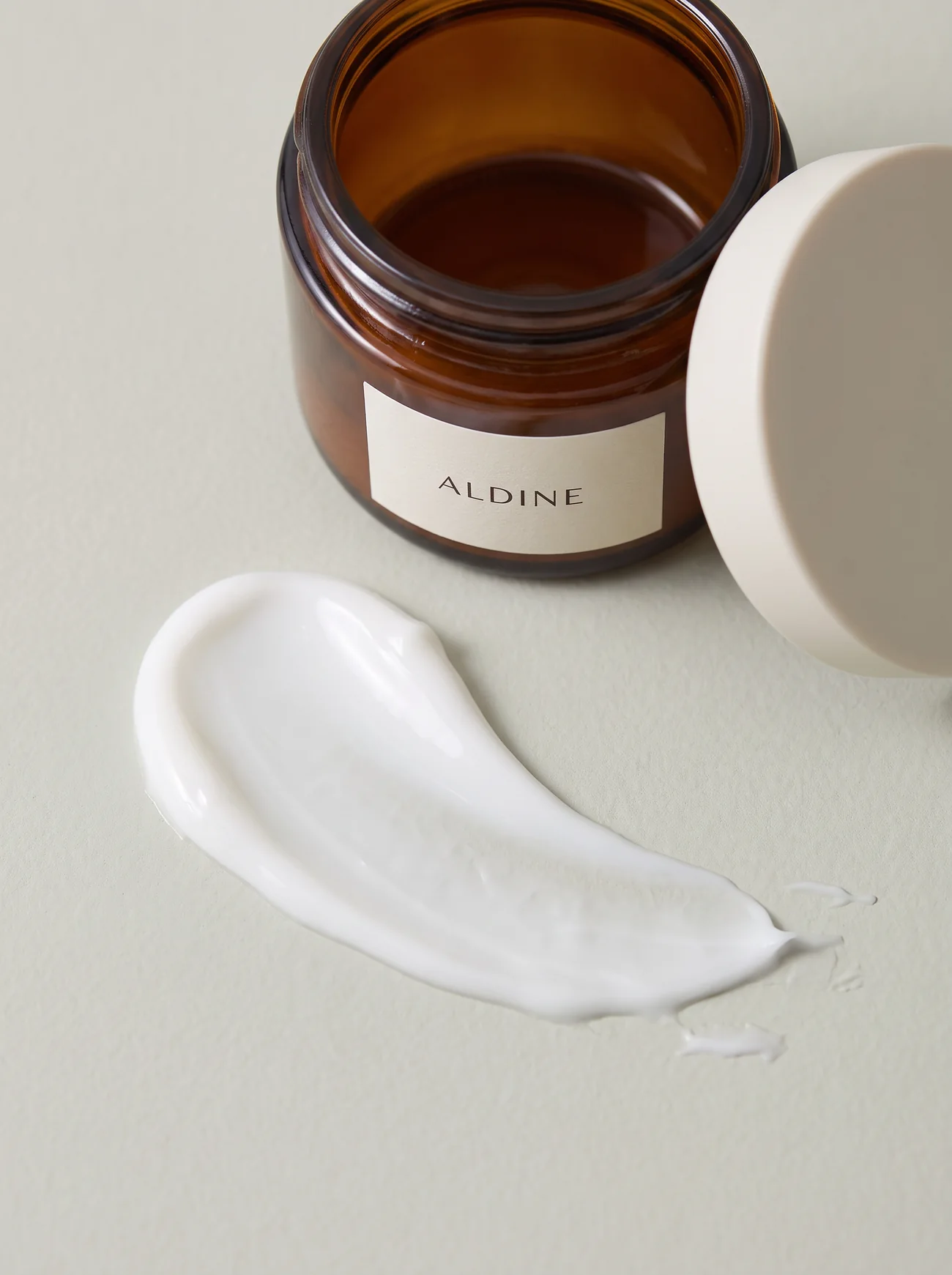A thick white cream swept across pale stone
