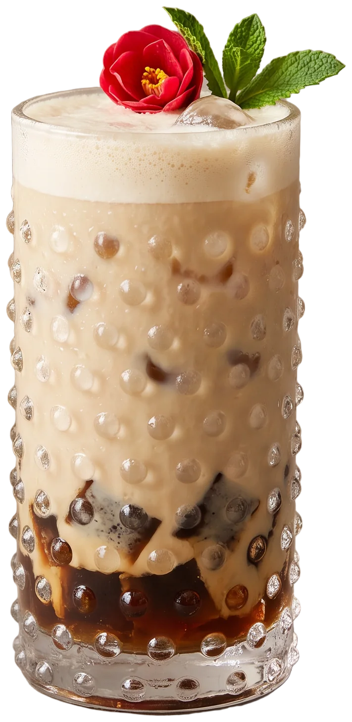 A tall hobnail glass of iced oat milk chai with tea jelly and a red flower