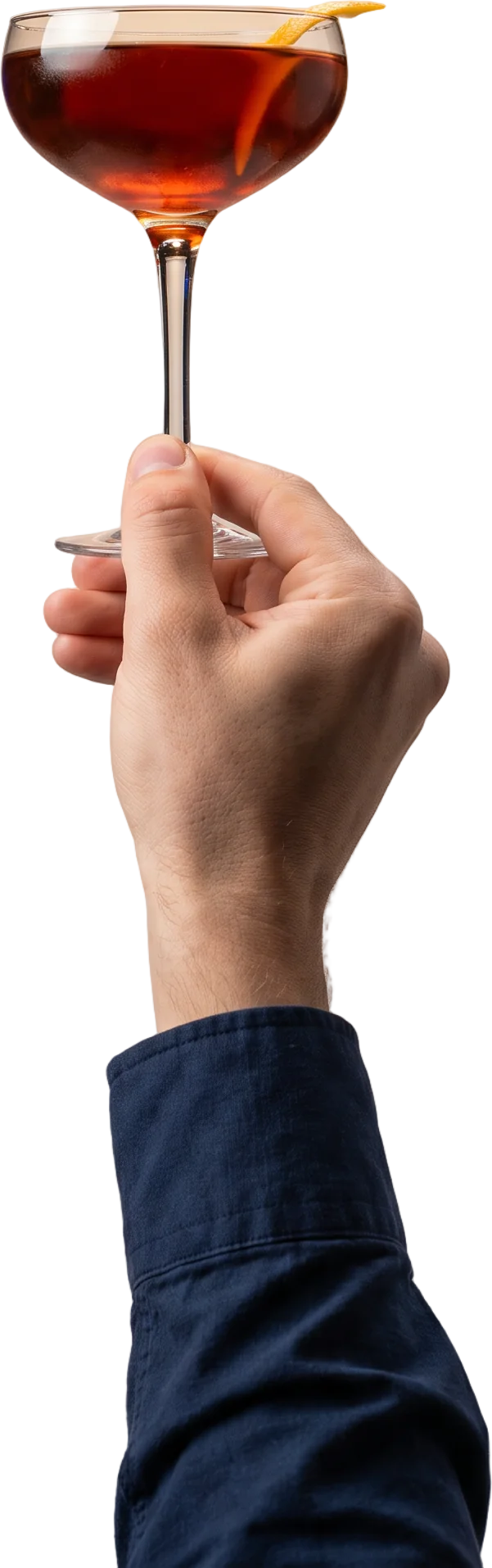 A hand holding a coupe glass of an amber cocktail