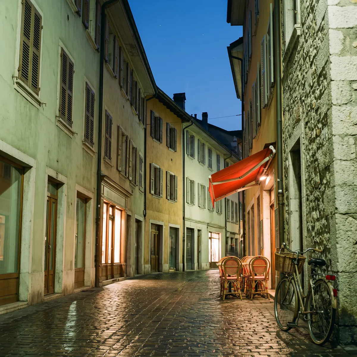 A narrow old town street at blue hour with a cafe awning