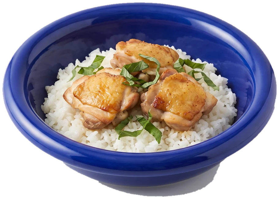 A wide cobalt-blue bowl of rice with seared chicken and herbs