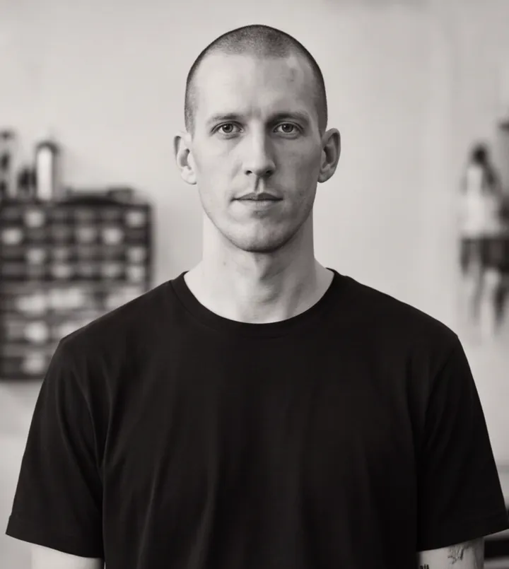 Black and white portrait of Kenji Arruda, a fictional tattoo artist